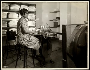 Blind woman, presumably Charlotte Rohr, working with a braille press, dictaphone and stereotype, New York, 1933